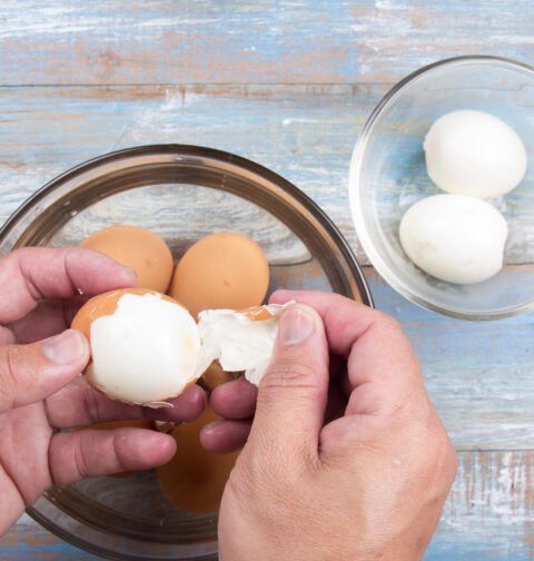 a person peeling eggs