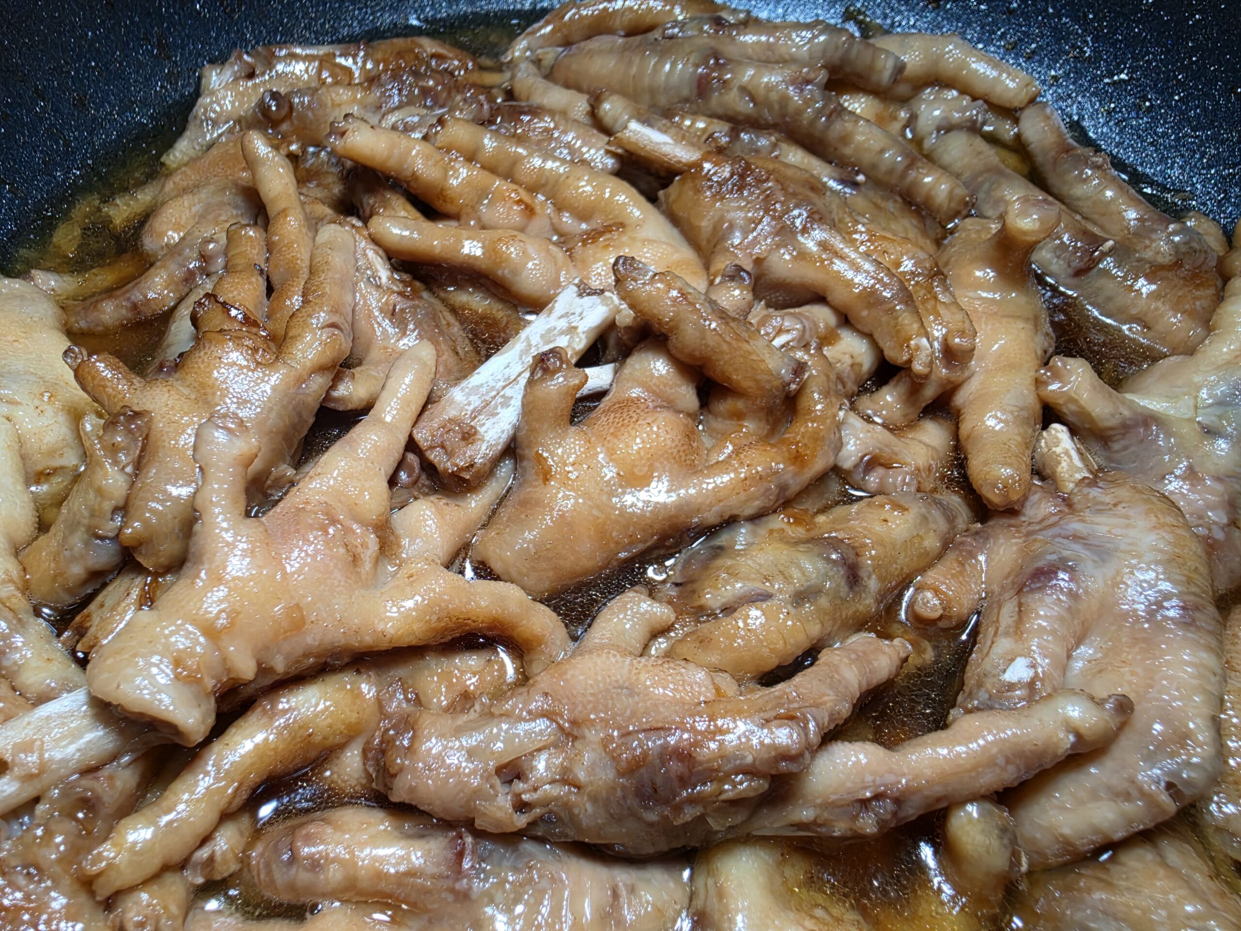 Tender Filipino chicken feet adobo simmered in a rich, thick soy sauce and vinegar sauce.