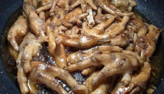 Tender Filipino chicken feet adobo simmered in a rich, thick soy sauce and vinegar sauce.