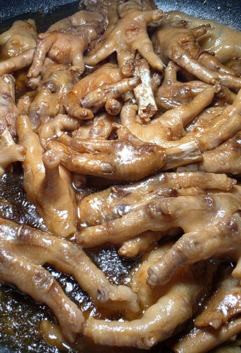 Tender Filipino chicken feet adobo simmered in a rich, thick soy sauce and vinegar sauce.