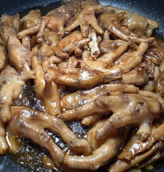 Tender Filipino chicken feet adobo simmered in a rich, thick soy sauce and vinegar sauce.